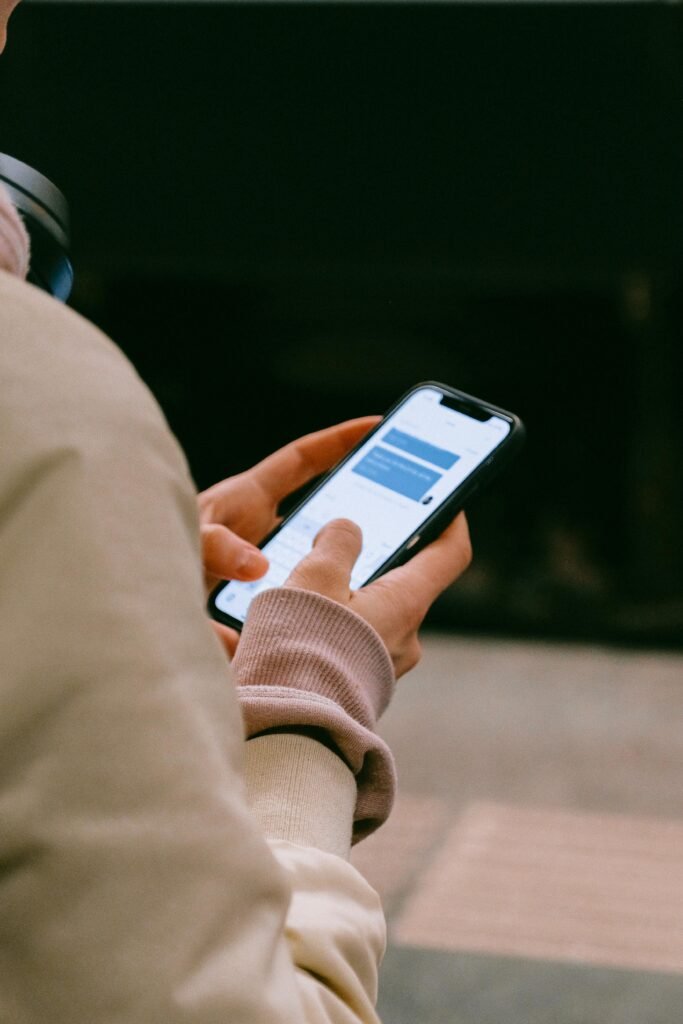 pexels-photo-3943951-3943951 A person using a smartphone for texting, focusing on their hands and device screen.